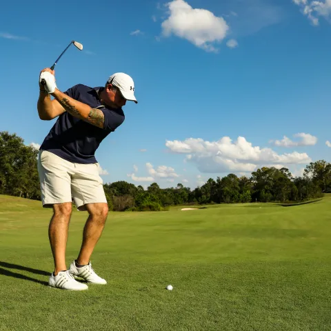 Golfer aiming at the golf ball